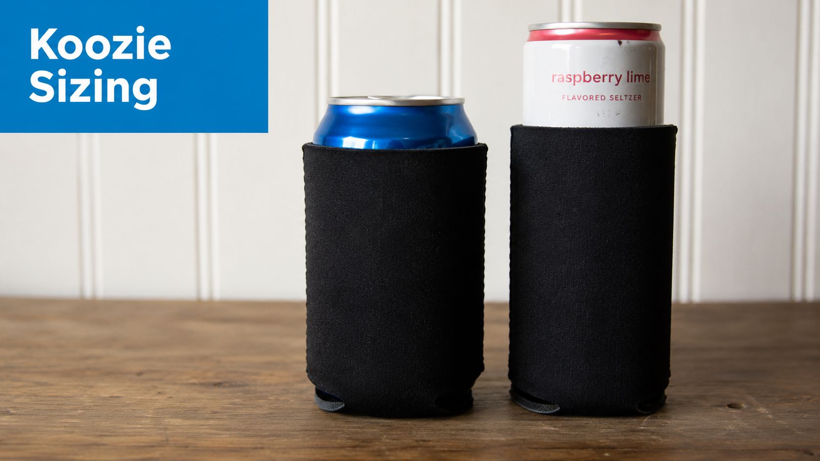 A standard blue soda can and a tall slim raspberry lime seltzer can in black foam koozies.