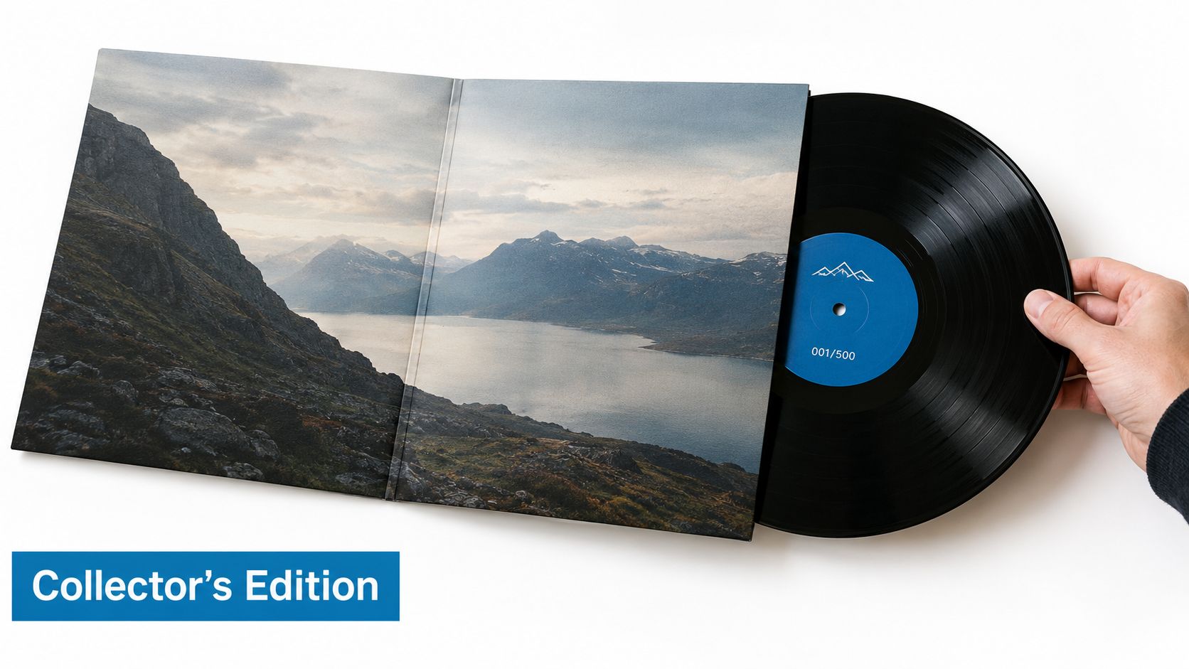 A hand holding a limited edition vinyl record with mountain scenery artwork inside a custom gatefold jacket.