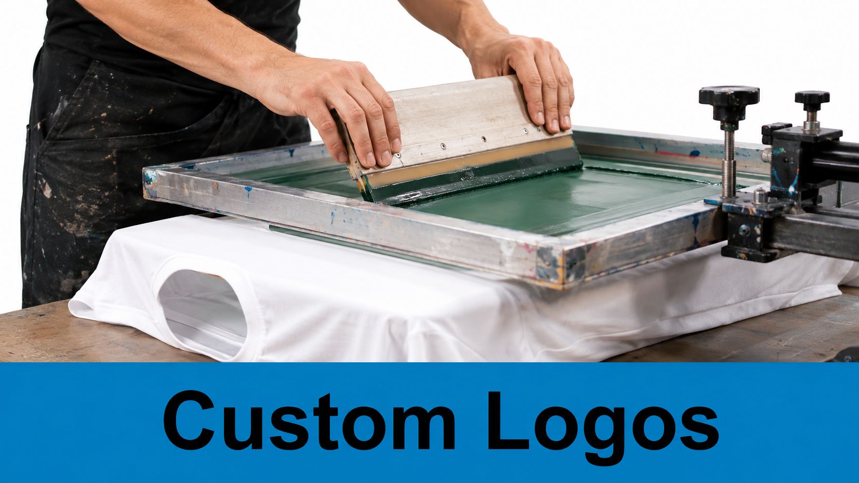 A professional printer uses a squeegee to apply ink onto a white t-shirt using a screen frame.